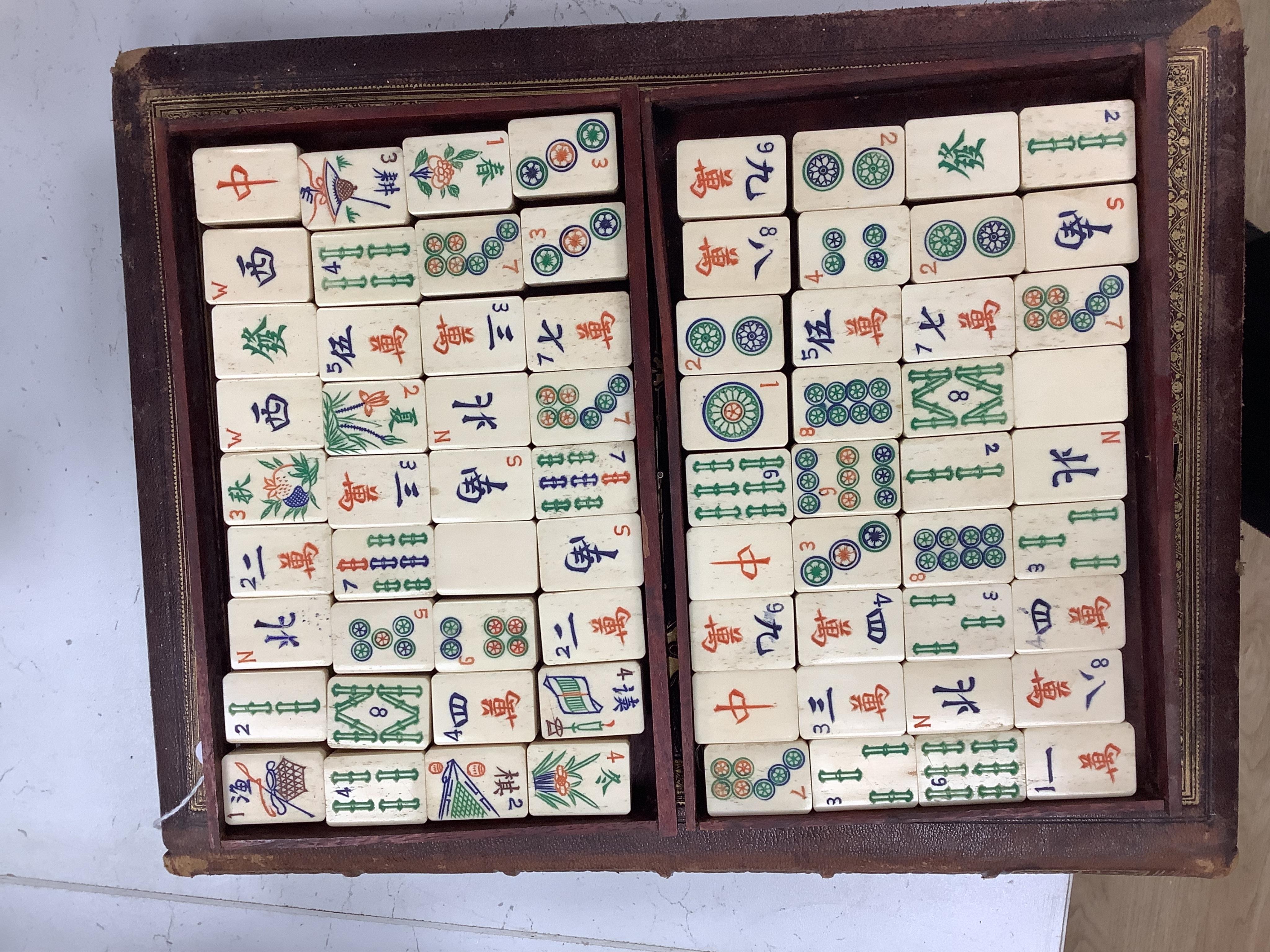 A cased Chinese mahjong set, bone pieces